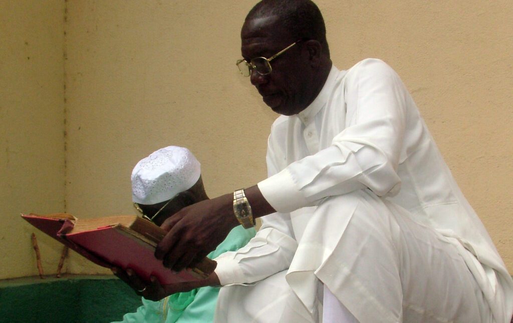 A Muslim man reads a Koran at the Great Mosque in Kankan, Guinea. Pic SIM photographer