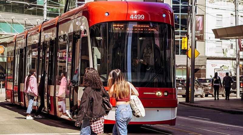 People walking in Toronto with tram in view. Pic Rasheeque Ahnaf, Pexels